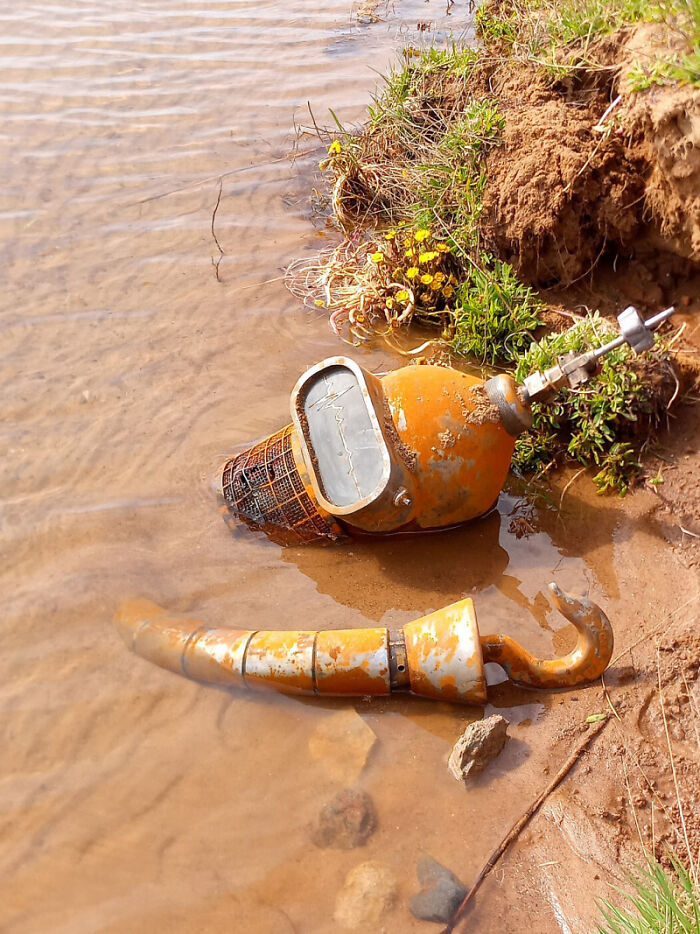 Rusty industrial equipment partly submerged in water, evoking a 'hmmm' reaction with its unusual placement and weathered appearance. Rusty industrial equipment partly submerged in water, evoking a 'hmmm' reaction with its unusual placement and weathered appearance.
