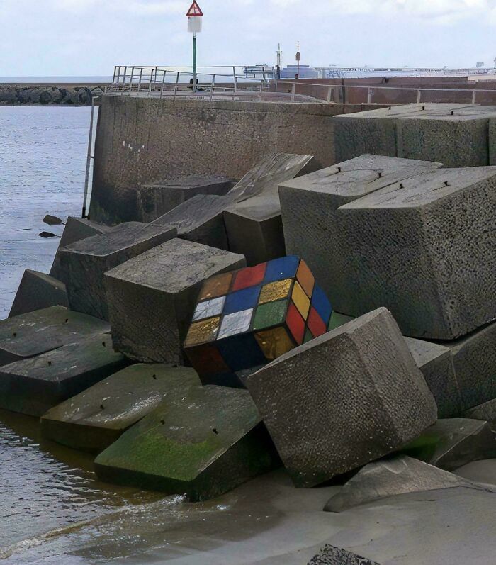 Giant Rubik's Cube structure among concrete blocks near the ocean. Giant Rubik's Cube structure among concrete blocks near the ocean.