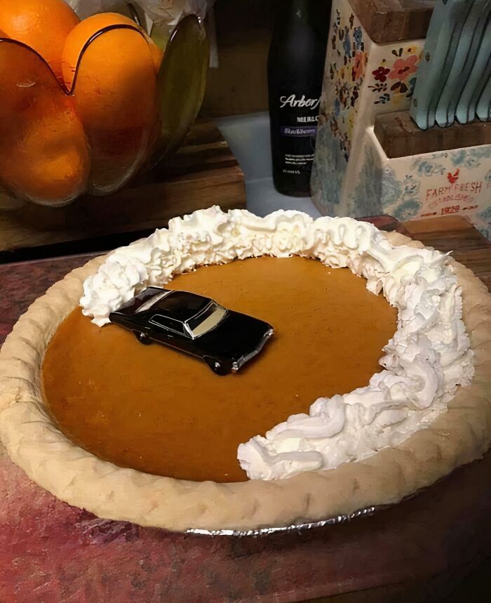 Pie with a toy car partially covered in whipped cream, creating a 'hmmm' moment. Pie with a toy car partially covered in whipped cream, creating a 'hmmm' moment.