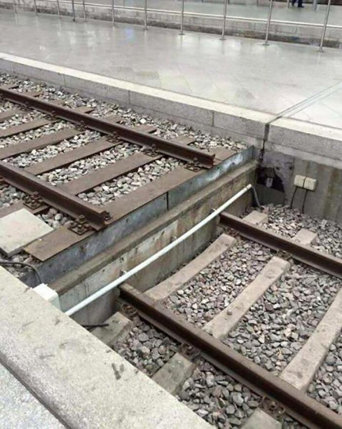 Train tracks abruptly ending, leading to a puzzling sight that makes you go 'hmmm'. Train tracks abruptly ending, leading to a puzzling sight that makes you go 'hmmm'.
